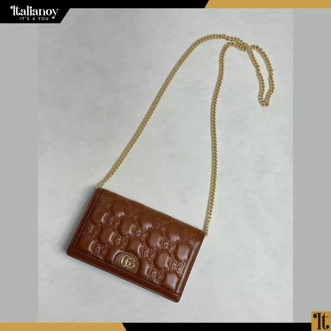 A square padded bag with flap details and chain