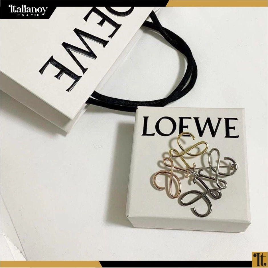 Anagram brooch in metal